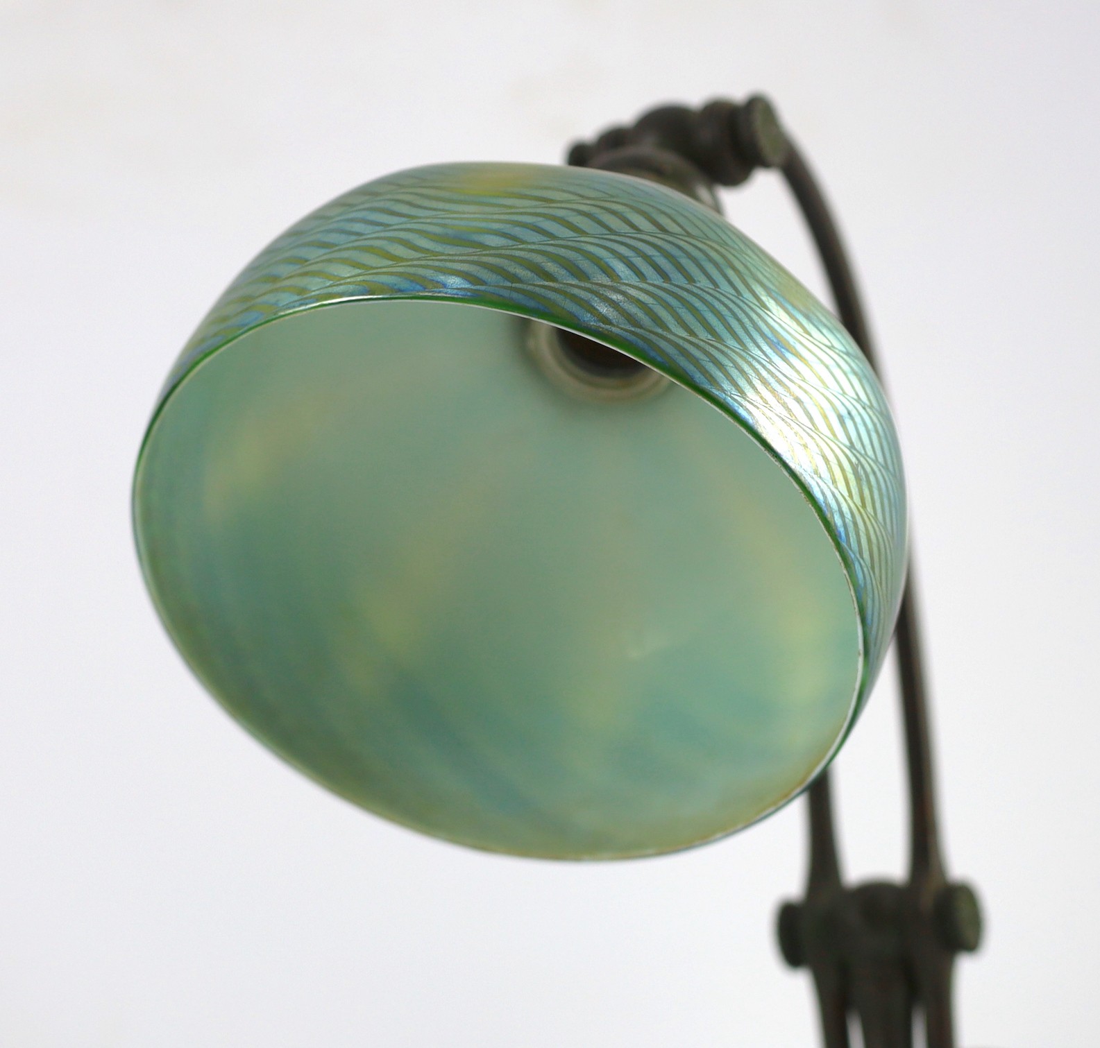 Tiffany Studios, a counter-balance patinated bronze desk lamp with ‘favrile’ glass shade, c.1905, maximum height 41cm, shade 17.3cm diameter